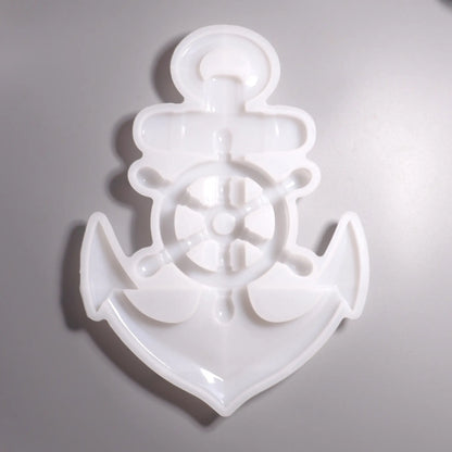 Weiße Silikon Gießform Anker mit Steuerrad Maritime Dekoration. Hintergrund grau. 